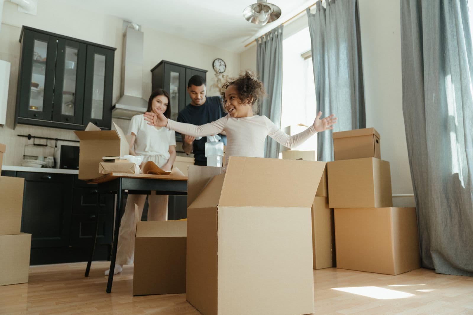 A family unpacking boxes in their new home